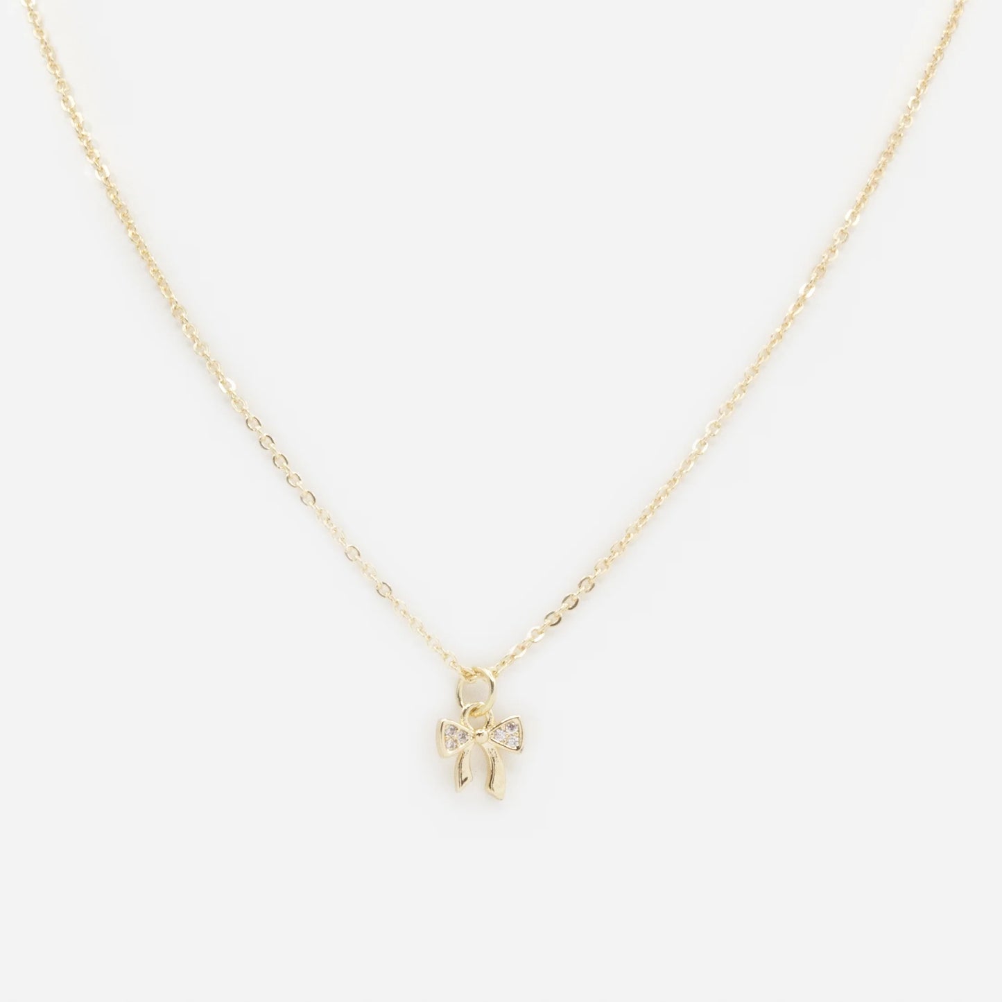 Small bow charm golden necklace with cubic zirconia