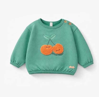 Green sweater with cherries