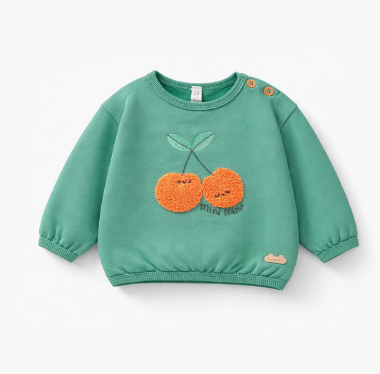 Green sweater with cherries