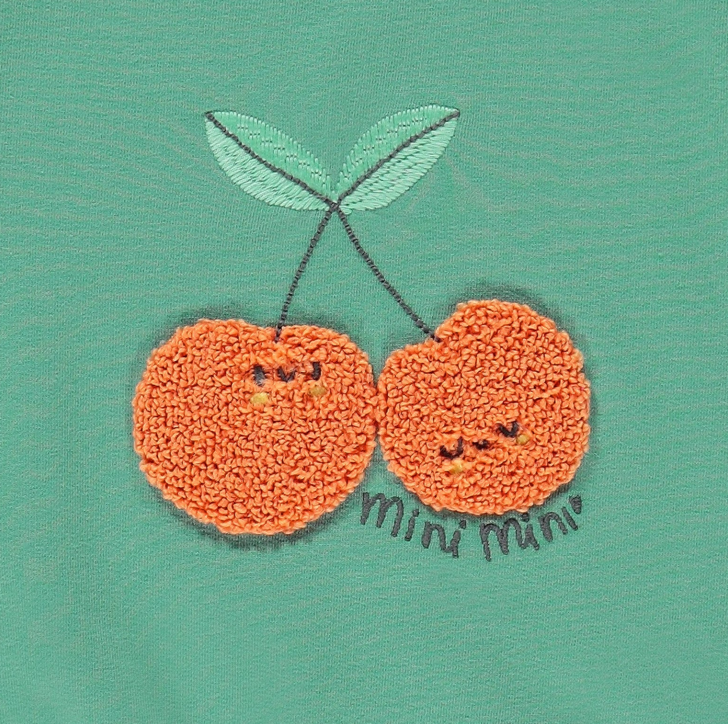 Green sweater with cherries