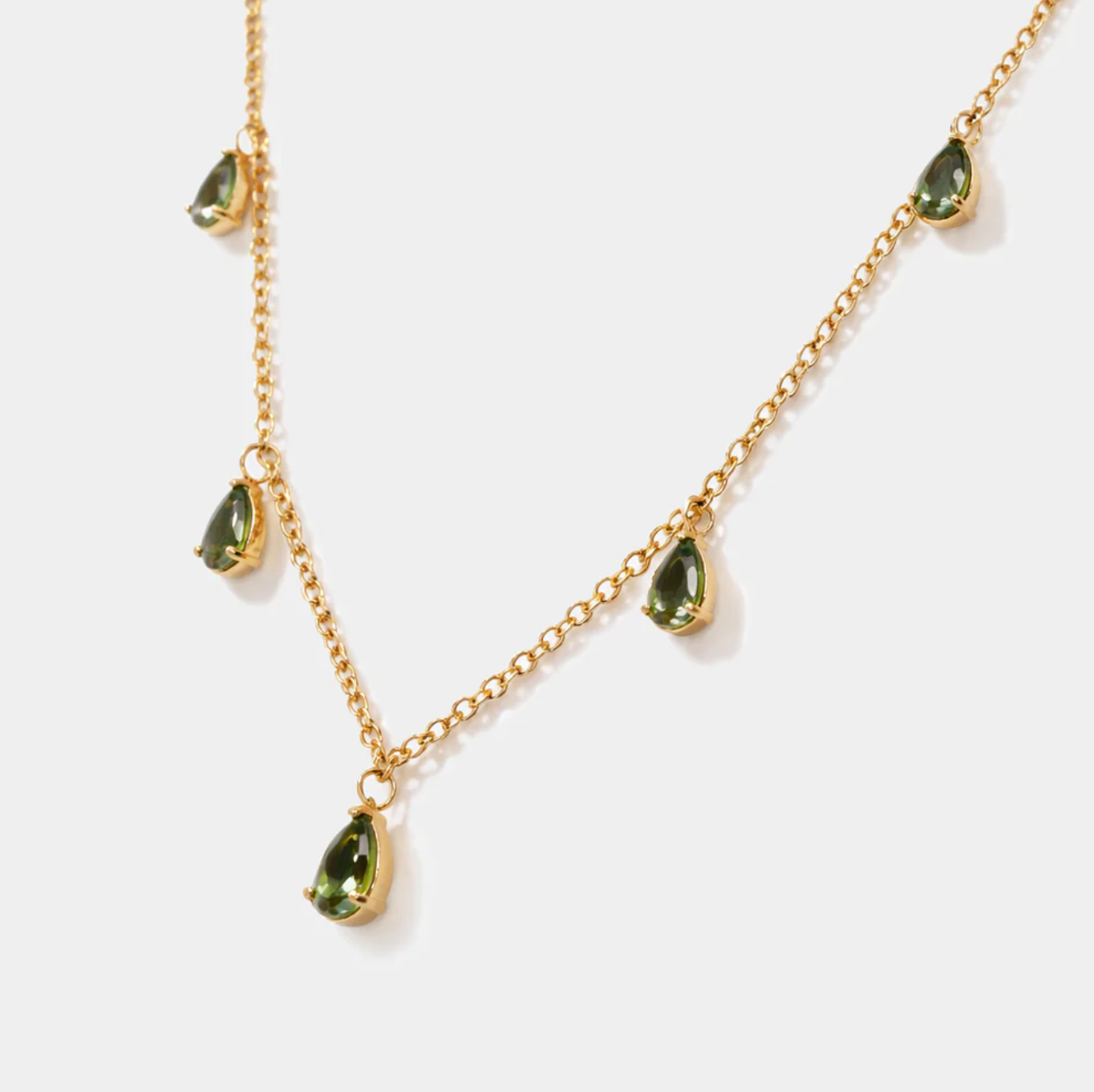 Golden necklace with green stone charm